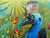 street art image of a cassowary with a bright blue head and a backdrop of jungle including palms and birds of paradise flowers