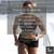 short haired afro american woman in short shorts and crop running up stairs